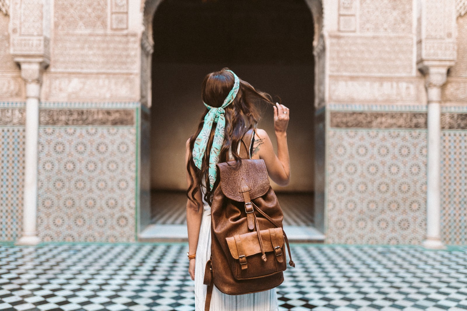 Traveller seen from behind inside a documented Marrakech interior