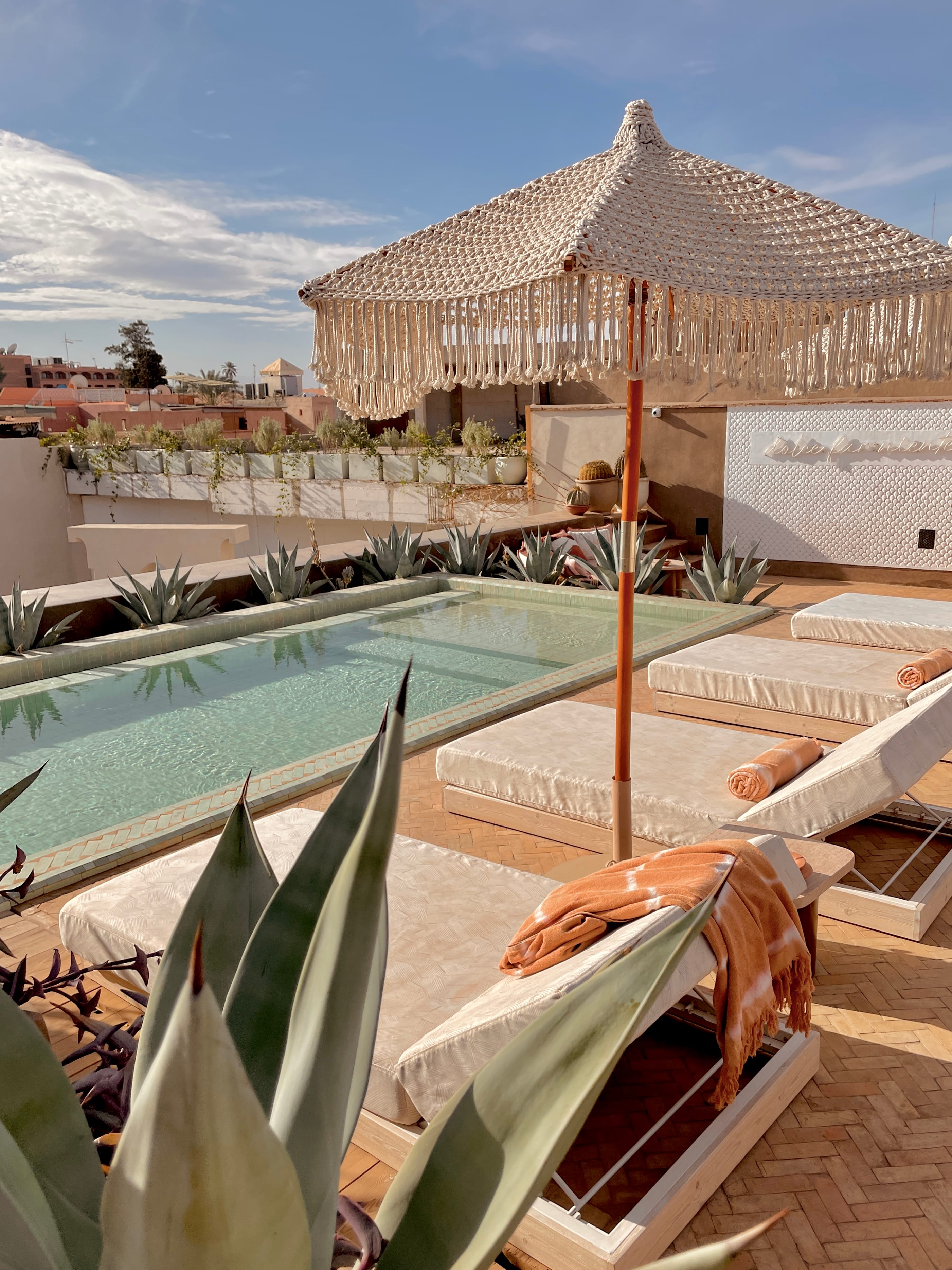 Sun loungers and plunge pool on the panoramic rooftop of 72 Marrakech