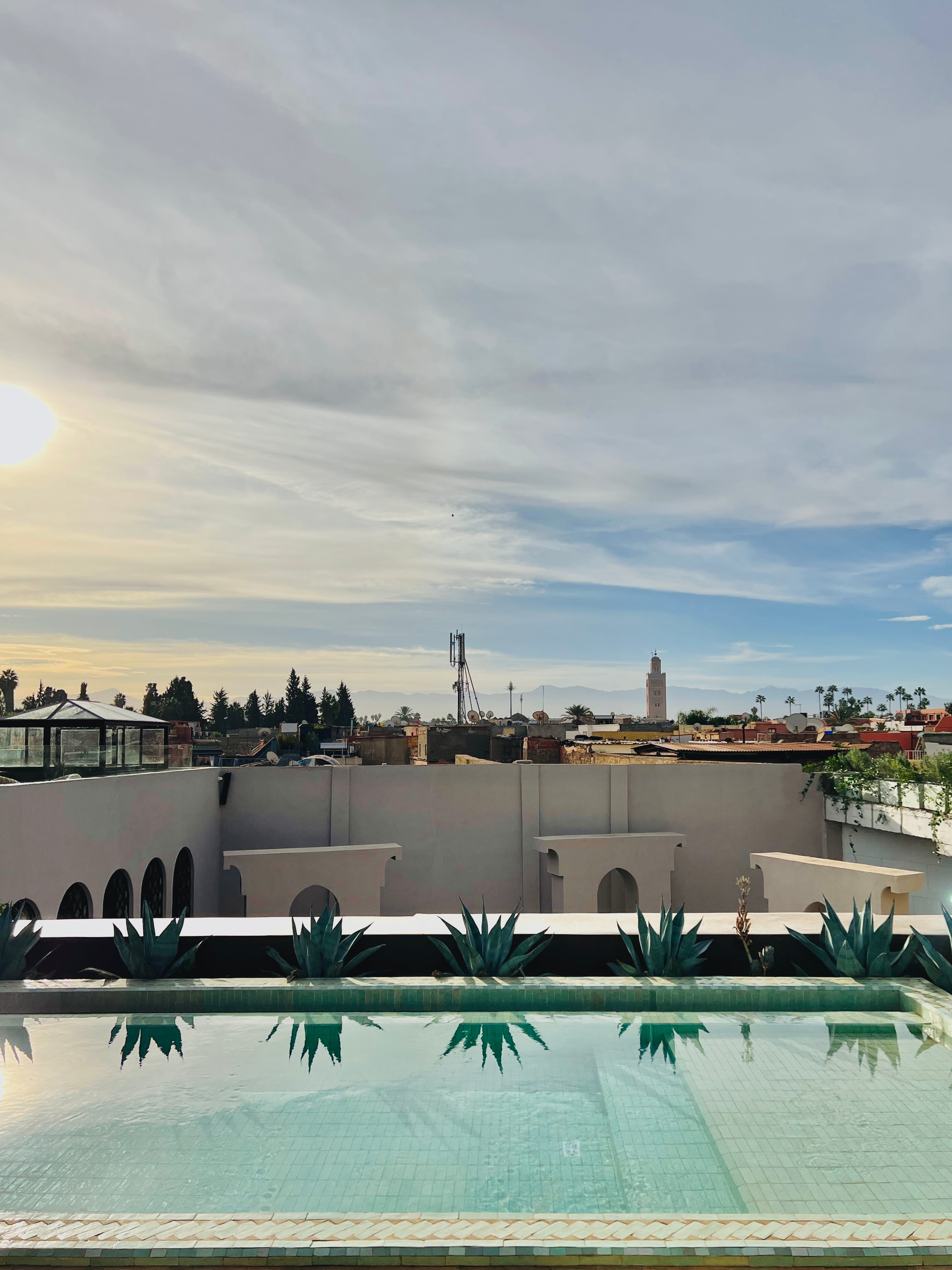 Rooftop plunge pool looking across the Medina to the Koutoubia and Atlas Mountains