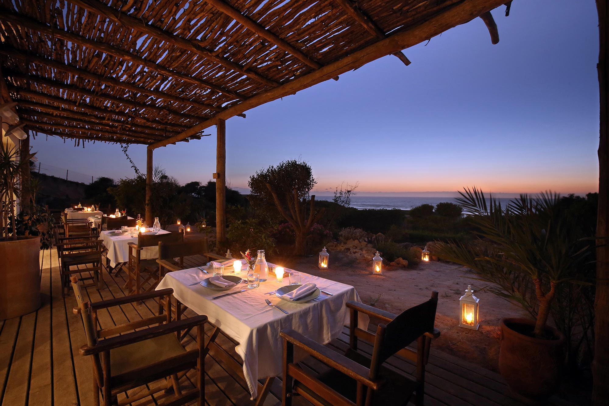 Candlelit dinner terrace overlooking the Atlantic at Azalaï Beach Cottage