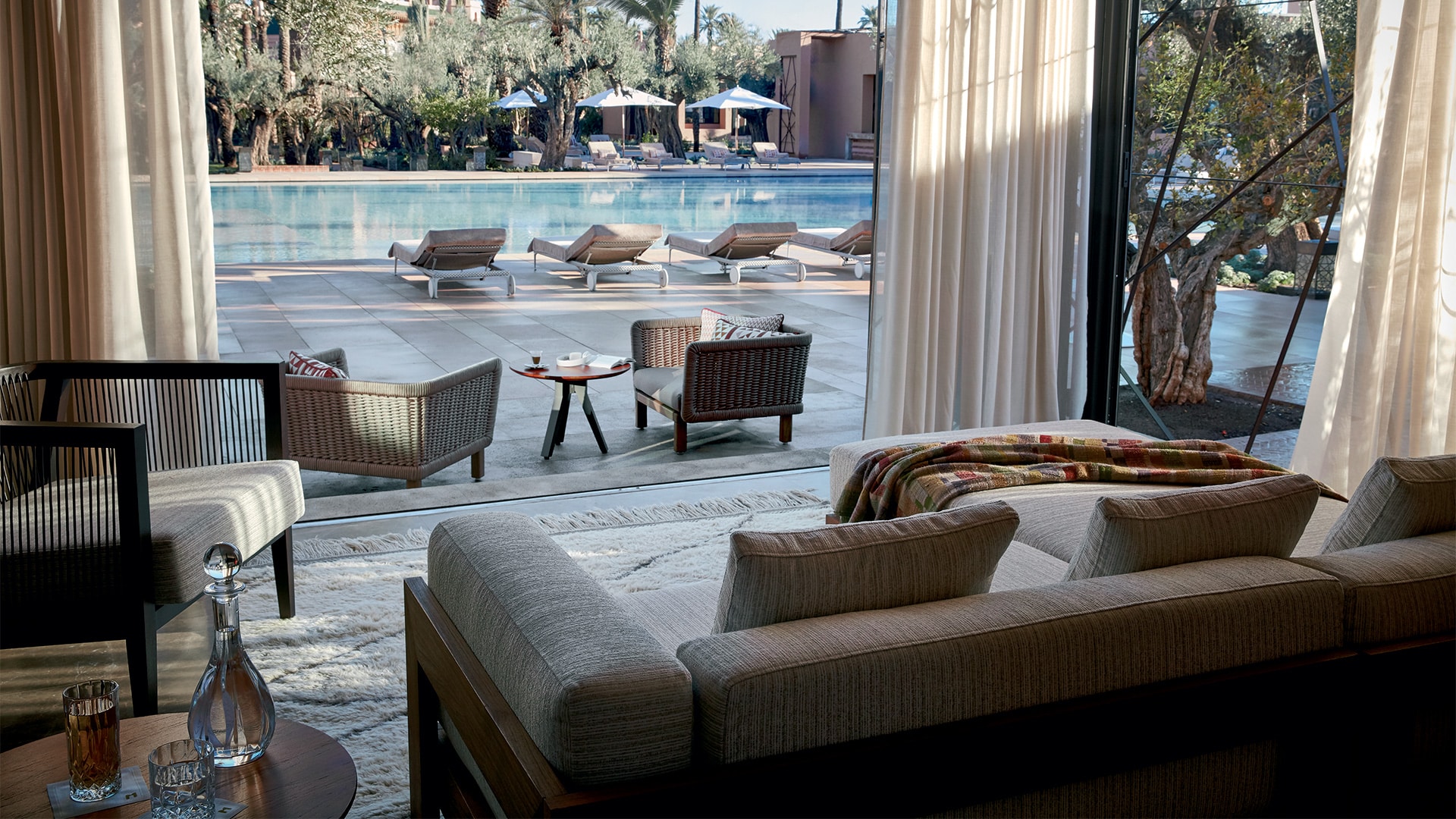 Lounge opening onto the garden swimming pool at Royal Mansour Marrakech
