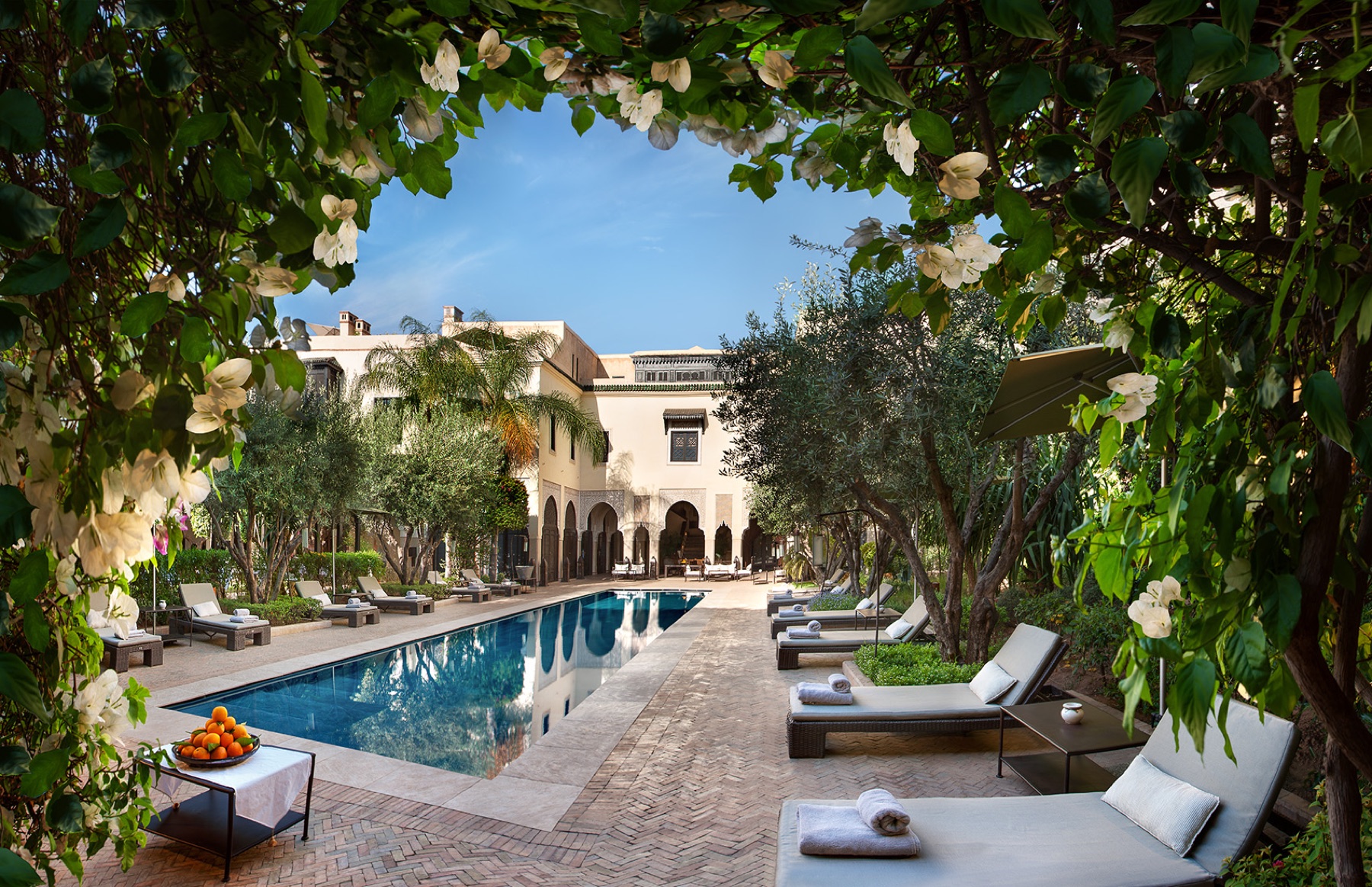 Long pool framed by orange trees in the Villa des Orangers garden