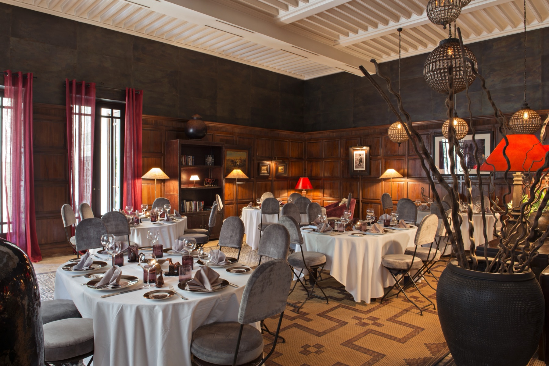Warm wood-panelled dining room at Villa des Orangers