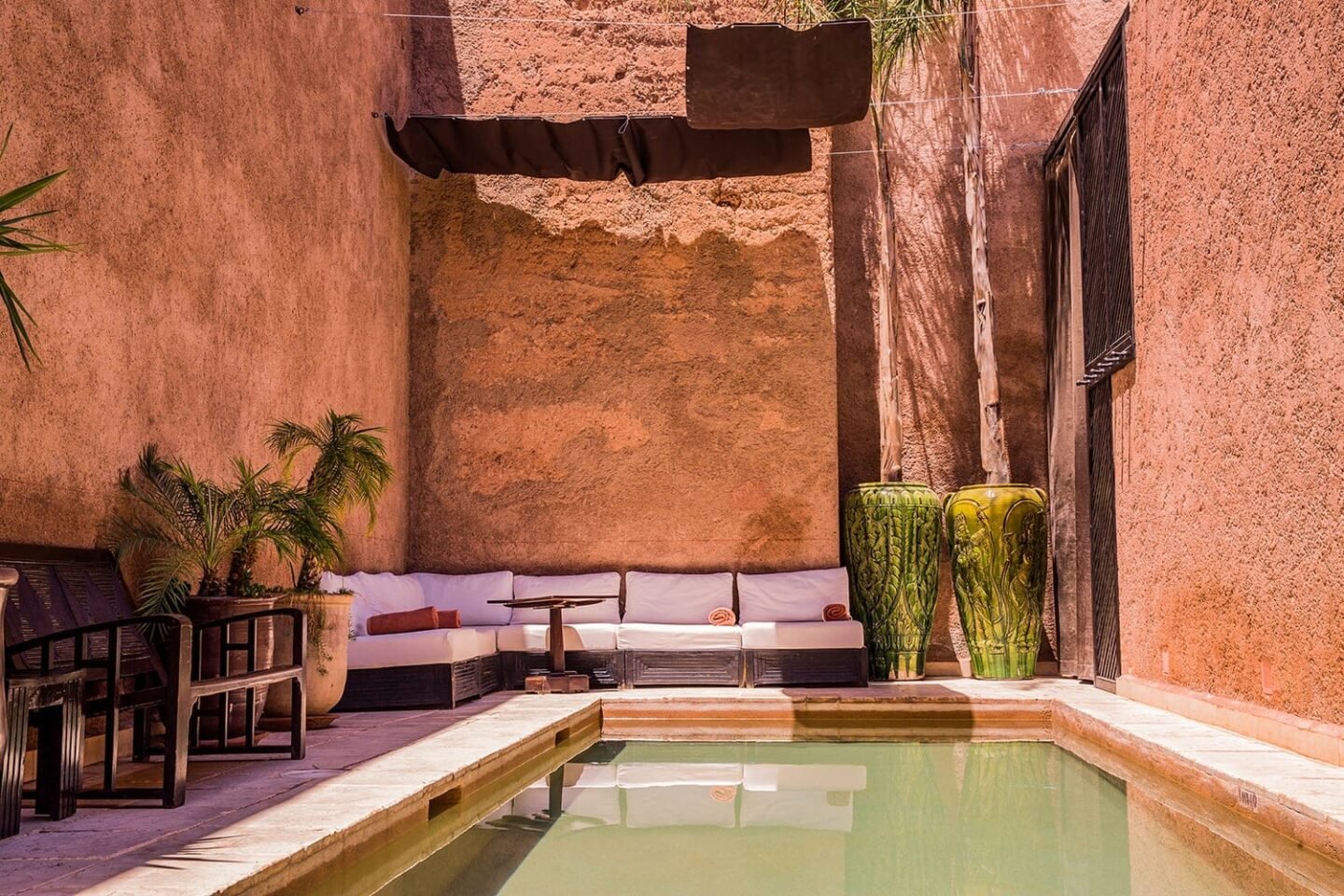 Small pool and shaded seating in Villa Makassar’s ochre patio