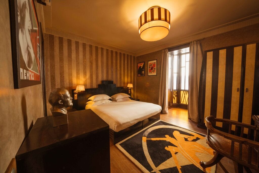 Rodchenko-inspired Deluxe Room with warm Art Deco furnishings
