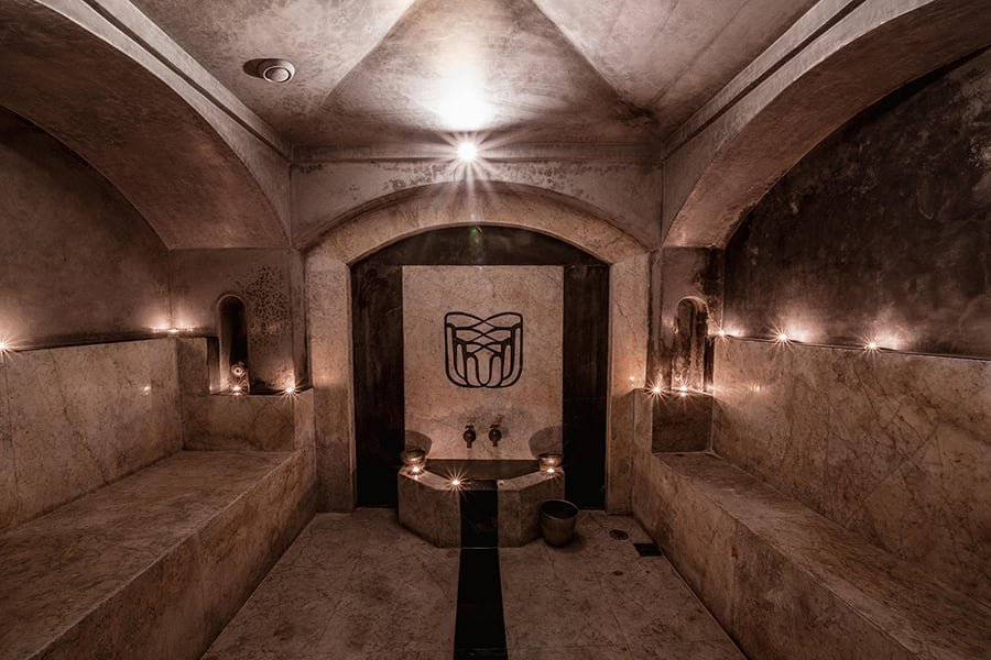 Stone benches and soft lighting in Villa Makassar’s traditional hammam